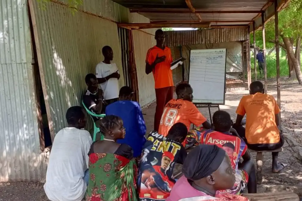 Facilitator presenting findings from the Rapid Needs Assessment on a board to inform Emergency Action Plans preparedness in Ulang and Nasir counties, South Sudan.